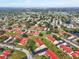 Aerial view of a neighborhood with lush landscaping, red roofs, and mature trees at 1421 57Th W St # 1421, Bradenton, FL 34209