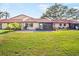 A home's backyard featuring a lawn, patio with grill, and screened in porch at 1421 57Th W St # 1421, Bradenton, FL 34209