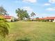 A large lawn area behind a row of homes with red tile roofs at 1421 57Th W St # 1421, Bradenton, FL 34209