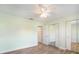 A light and airy bedroom with wood floors, ceiling fan, and closet with mirrored doors at 1421 57Th W St # 1421, Bradenton, FL 34209