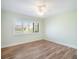 Bedroom featuring wood floors, shuttered windows, and ceiling fan with overhead lighting at 1421 57Th W St # 1421, Bradenton, FL 34209