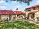 Beautiful condo with a red tiled roof, lush green lawn, and inviting walkways at 1421 57Th W St # 1421, Bradenton, FL 34209