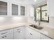 Bright kitchen features white cabinets, subway tile backsplash, and quartz countertops at 1421 57Th W St # 1421, Bradenton, FL 34209