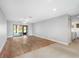 Open-concept living space with hardwood flooring and an abundance of natural light at 1421 57Th W St # 1421, Bradenton, FL 34209