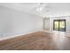 Spacious living room featuring wood floors, ceiling fan, and sliding door at 1421 57Th W St # 1421, Bradenton, FL 34209