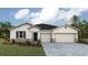 Charming single-story home featuring a three-car garage and stone accents at 17134 James Trl, Parrish, FL 34219