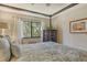 Serene bedroom with floral bedding, dresser and large windows offering lush views at 1720 Glenhouse Dr # Gl430, Sarasota, FL 34231