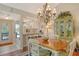 Cozy dining space showcasing an adjacent kitchen and a decorative display cabinet at 1720 Glenhouse Dr # Gl430, Sarasota, FL 34231