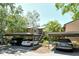 View of the condo exterior with covered parking and lush landscaping at 1720 Glenhouse Dr # Gl430, Sarasota, FL 34231