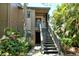 Exterior entrance to a condo with gray stairs surrounded by tropical plants at 1720 Glenhouse Dr # Gl430, Sarasota, FL 34231