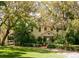 Traditional style home with mature trees, landscaping and a green lawn at 1720 Glenhouse Dr # Gl430, Sarasota, FL 34231