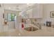 Functional kitchen featuring white cabinetry, stainless steel sink, and granite countertops at 1720 Glenhouse Dr # Gl430, Sarasota, FL 34231