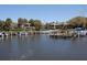 Waterfront view of a private marina with boats docked at the slips near residential buildings on a clear day at 1720 Glenhouse Dr # Gl430, Sarasota, FL 34231