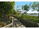 Scenic wooden boardwalk path winds through lush greenery, leading to tranquil waterfront views at 1720 Glenhouse Dr # Gl430, Sarasota, FL 34231