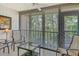 Enclosed lanai features tile floors, seating, and serene views of lush greenery at 1720 Glenhouse Dr # Gl430, Sarasota, FL 34231