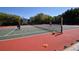Outdoor tennis court surrounded by trees, perfect for recreational activities at 1720 Glenhouse Dr # Gl430, Sarasota, FL 34231