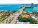 Aerial view of residences, roads, and palm trees leading towards a bridge over a waterway at 1750 Benjamin Franklin Dr # 6B, Sarasota, FL 34236