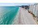 Beautiful turquoise water along the beach with luxury condo buildings at 1750 Benjamin Franklin Dr # 6B, Sarasota, FL 34236