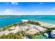 Expansive coastal view with beautiful ocean, a building, and a park with tennis court at 1750 Benjamin Franklin Dr # 6B, Sarasota, FL 34236