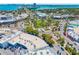 High angle shot of a green roundabout with palm trees, roads, and buildings in a city at 1750 Benjamin Franklin Dr # 6B, Sarasota, FL 34236
