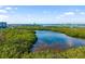 High angle scenic view of a verdant wetland area near a city and waterway under a blue sky at 1750 Benjamin Franklin Dr # 6B, Sarasota, FL 34236