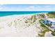 Aerial shot of beach and modern home with a pool and lush surrounding vegetation at 1750 Benjamin Franklin Dr # 6B, Sarasota, FL 34236