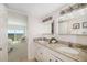 Elegant bathroom featuring dual sinks, granite countertops, and views of the ocean at 1750 Benjamin Franklin Dr # 6B, Sarasota, FL 34236