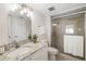 Bathroom with granite vanity and tiled walk-in shower at 1750 Benjamin Franklin Dr # 6B, Sarasota, FL 34236