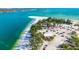 High angle shot of a parking area near beach access with buildings, trees and white sands at 1750 Benjamin Franklin Dr # 6B, Sarasota, FL 34236