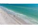 Calm turquoise ocean with soft white sand for a peaceful and scenic beach view at 1750 Benjamin Franklin Dr # 6B, Sarasota, FL 34236