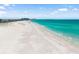 Beautiful beach with turquoise ocean water and soft white sand on a sunny day at 1750 Benjamin Franklin Dr # 6B, Sarasota, FL 34236