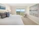 Comfortable bedroom with water view features calm decor and comfortable seating at 1750 Benjamin Franklin Dr # 6B, Sarasota, FL 34236