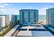 Exterior shows a high-rise condo building and a parking structure near the beach at 1750 Benjamin Franklin Dr # 6B, Sarasota, FL 34236