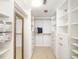 Walk in closet with extensive shelving and a dressing mirror at 1750 Benjamin Franklin Dr # 6B, Sarasota, FL 34236