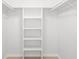 A walk-in closet with white shelving units and hanging rods, ready for organization at 1750 Benjamin Franklin Dr # 6B, Sarasota, FL 34236