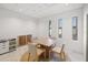 Bright conference room featuring a square table, four chairs, and natural light from three windows at 1750 Benjamin Franklin Dr # 6B, Sarasota, FL 34236