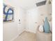 A well-lit entryway with modern decor, tile flooring, and a neutral color palette creates a welcoming first impression at 1750 Benjamin Franklin Dr # 6B, Sarasota, FL 34236