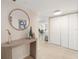Inviting entryway featuring a decorative mirror, table, and tile flooring, leading into a bright living space at 1750 Benjamin Franklin Dr # 6B, Sarasota, FL 34236