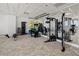 On-site gym with modern exercise equipment, weights, mirrored walls, and a patterned carpet at 1750 Benjamin Franklin Dr # 6B, Sarasota, FL 34236