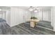 Hallway with carpet, mirror, and small table with plants at 1750 Benjamin Franklin Dr # 6B, Sarasota, FL 34236