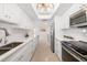 Bright modern kitchen with long countertops, stainless steel appliances, and plenty of cabinet space at 1750 Benjamin Franklin Dr # 6B, Sarasota, FL 34236
