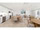 A kitchen and dining area featuring modern appliances, white cabinetry, and ample seating at 1750 Benjamin Franklin Dr # 6B, Sarasota, FL 34236