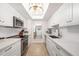 Clean and bright kitchen with white cabinets, stainless steel appliances, and an open layout design at 1750 Benjamin Franklin Dr # 6B, Sarasota, FL 34236