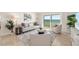 Bright living room with stylish furnishings and a sliding glass door to a balcony with ocean views at 1750 Benjamin Franklin Dr # 6B, Sarasota, FL 34236