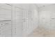 Well-lit mailbox area with numerous white mailboxes and a marble floor at 1750 Benjamin Franklin Dr # 6B, Sarasota, FL 34236