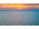 Serene sunset view over the ocean with the sun partially visible on the horizon at 1750 Benjamin Franklin Dr # 6B, Sarasota, FL 34236