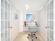 Bright home office with glass top desk, tile floors, and natural light at 1750 Benjamin Franklin Dr # 6B, Sarasota, FL 34236