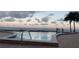 Beautiful pool at sunset with clear blue water and ocean views at 1750 Benjamin Franklin Dr # 6B, Sarasota, FL 34236