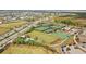 Aerial view of community sports complex featuring tennis courts, fields, and playgrounds at 17549 Timberline Pkwy, Punta Gorda, FL 33982
