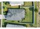 An aerial view of the home shows its roof, landscaping, and surrounding neighborhood at 17549 Timberline Pkwy, Punta Gorda, FL 33982